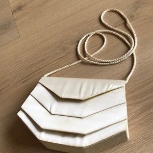 La Regale special occasion bag in cream with one indoor pocket.